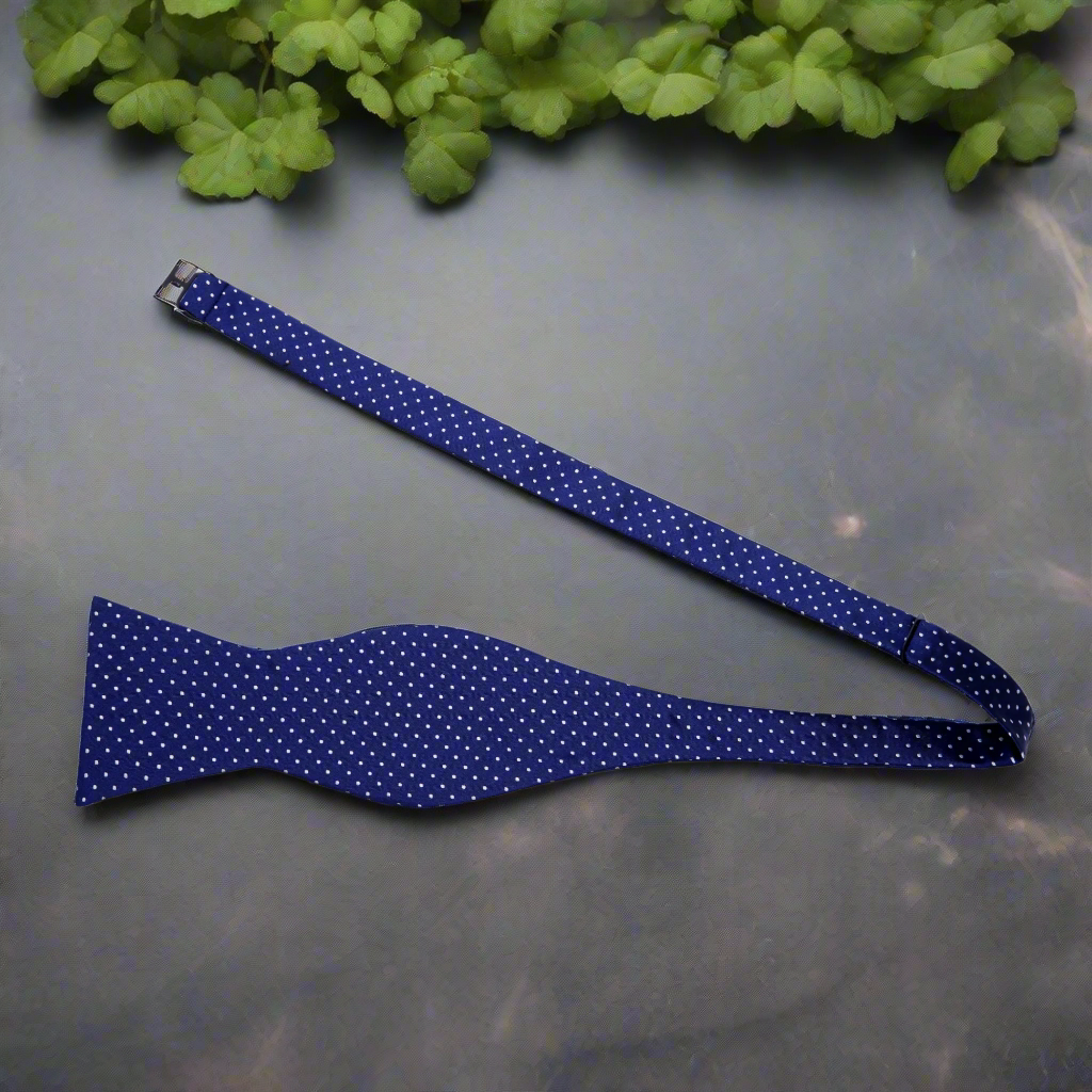 Close-up of burgundy microdot silk bow tie, highlighting its subtle contrast and elegance.