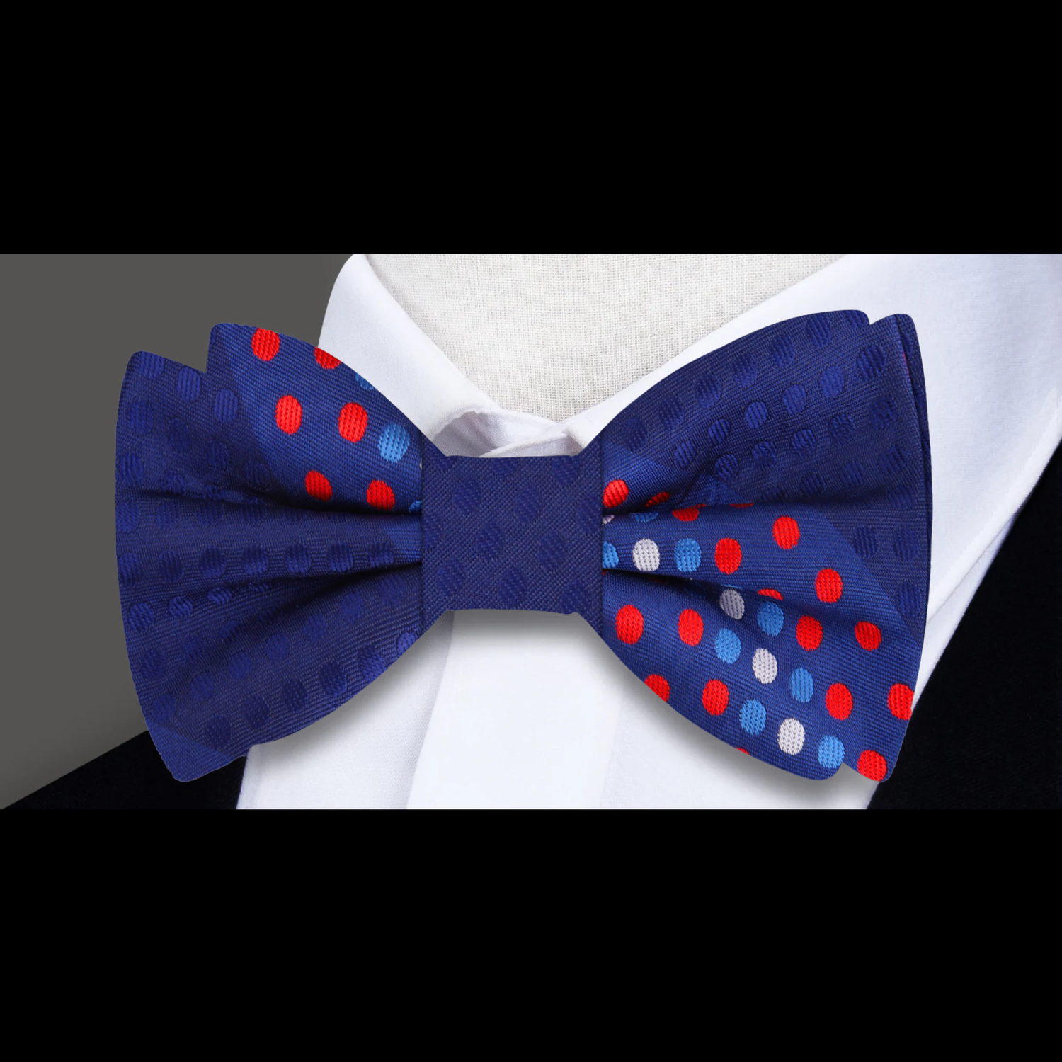 Bow tie displayed alongside a navy blue suit, perfect for business occasions.