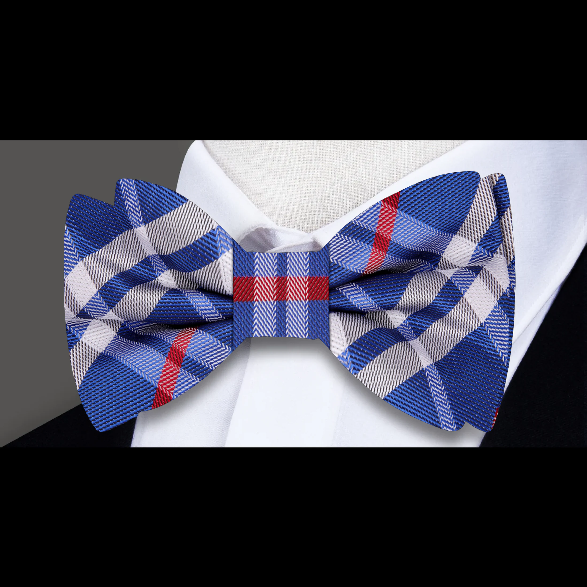 Model wearing the Blue, White, and Red Plaid Bow Tie at a wedding, paired with a navy suit.