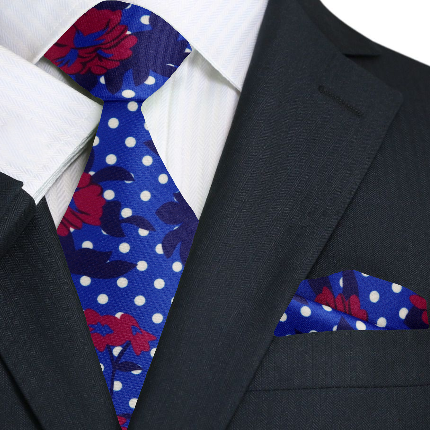 Close-up view of the silk ties intricate pattern featuring red hibiscus flowers and white dots against a blue background.