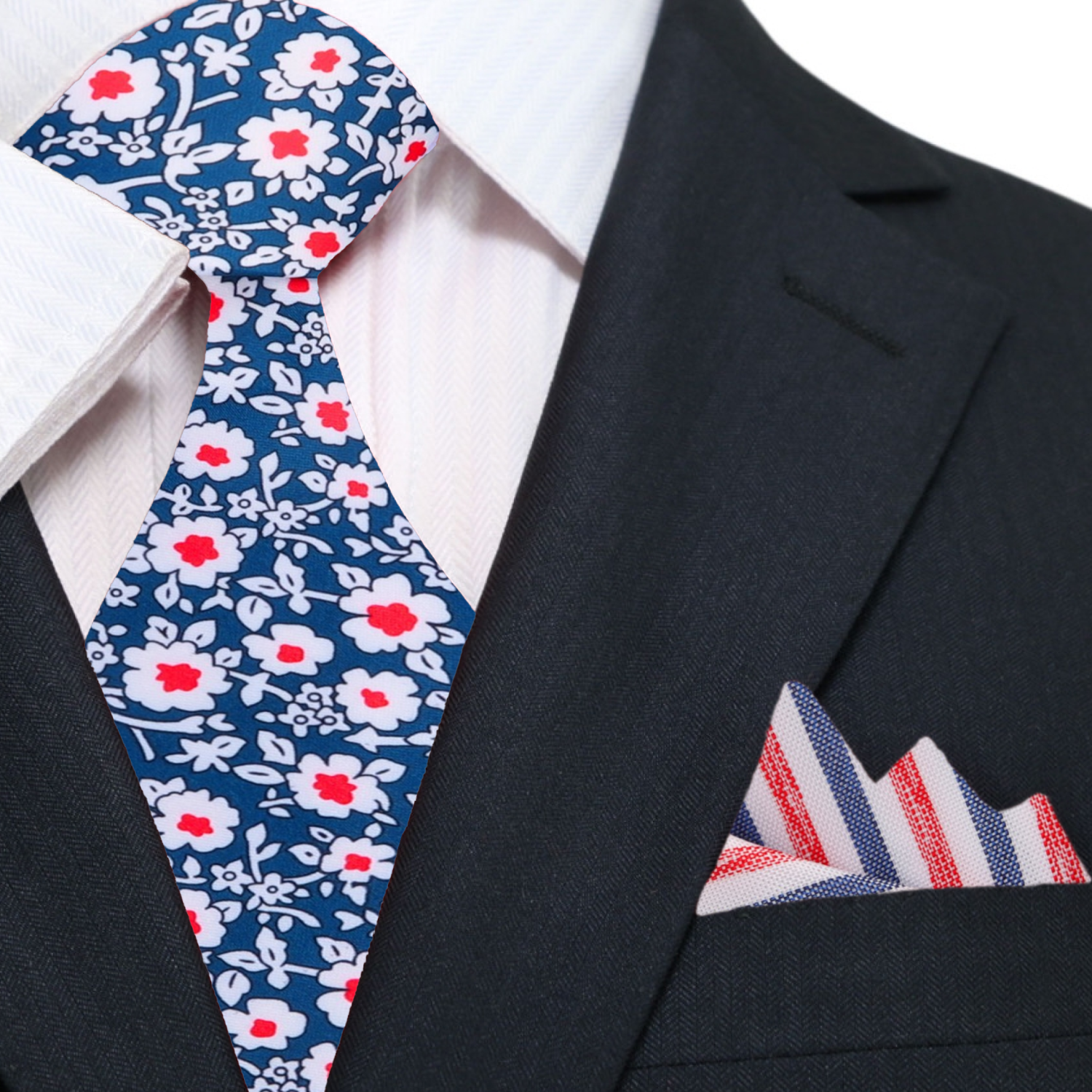 Model wearing the blue and red floral tie paired with a suit, demonstrating its suitability for formal occasions.