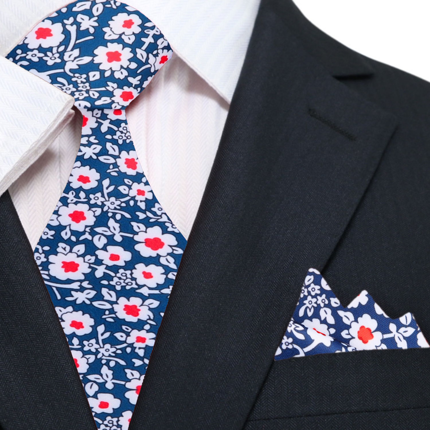 Close-up of the elegant blue and red floral silk necktie showcasing intricate flower patterns, perfect for a wedding.