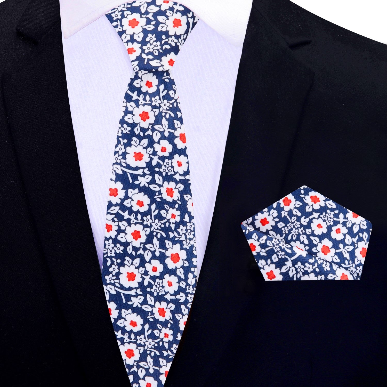 Detailed view of the matching pocket square, emphasizing the silk texture and floral design that complements the tie.