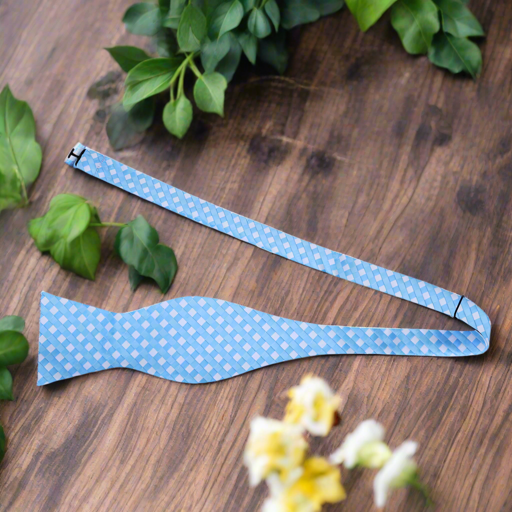 Front view of a stylish silk bow tie with light purple and white check pattern, suitable for weddings