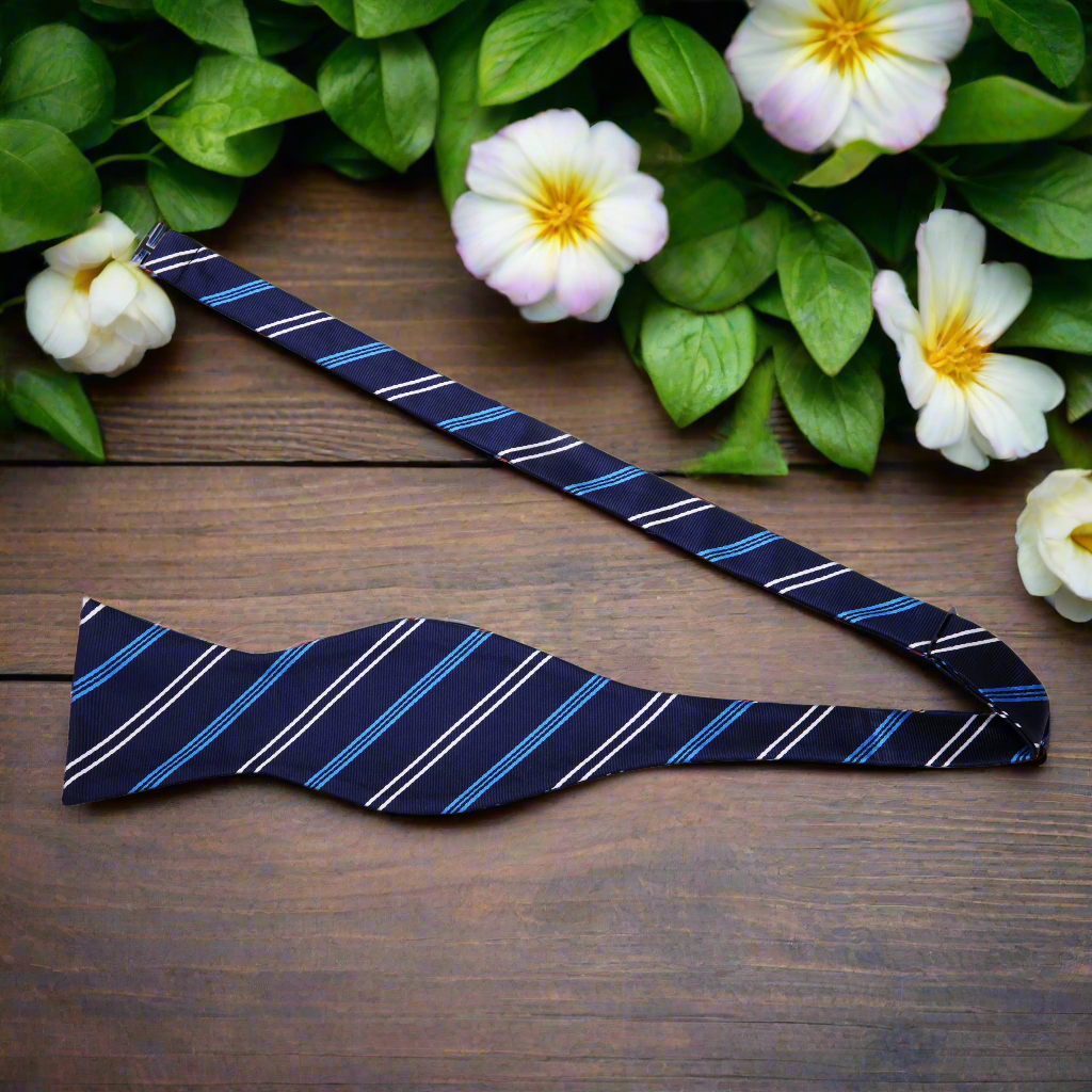 Close-up of premium silk stripe bow tie with matching pocket square set for formal wear