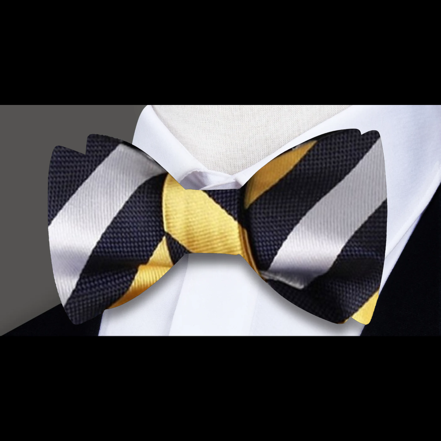 Man adjusting his bow tie at a wedding, featuring a black and white stripe pattern for a classic look.