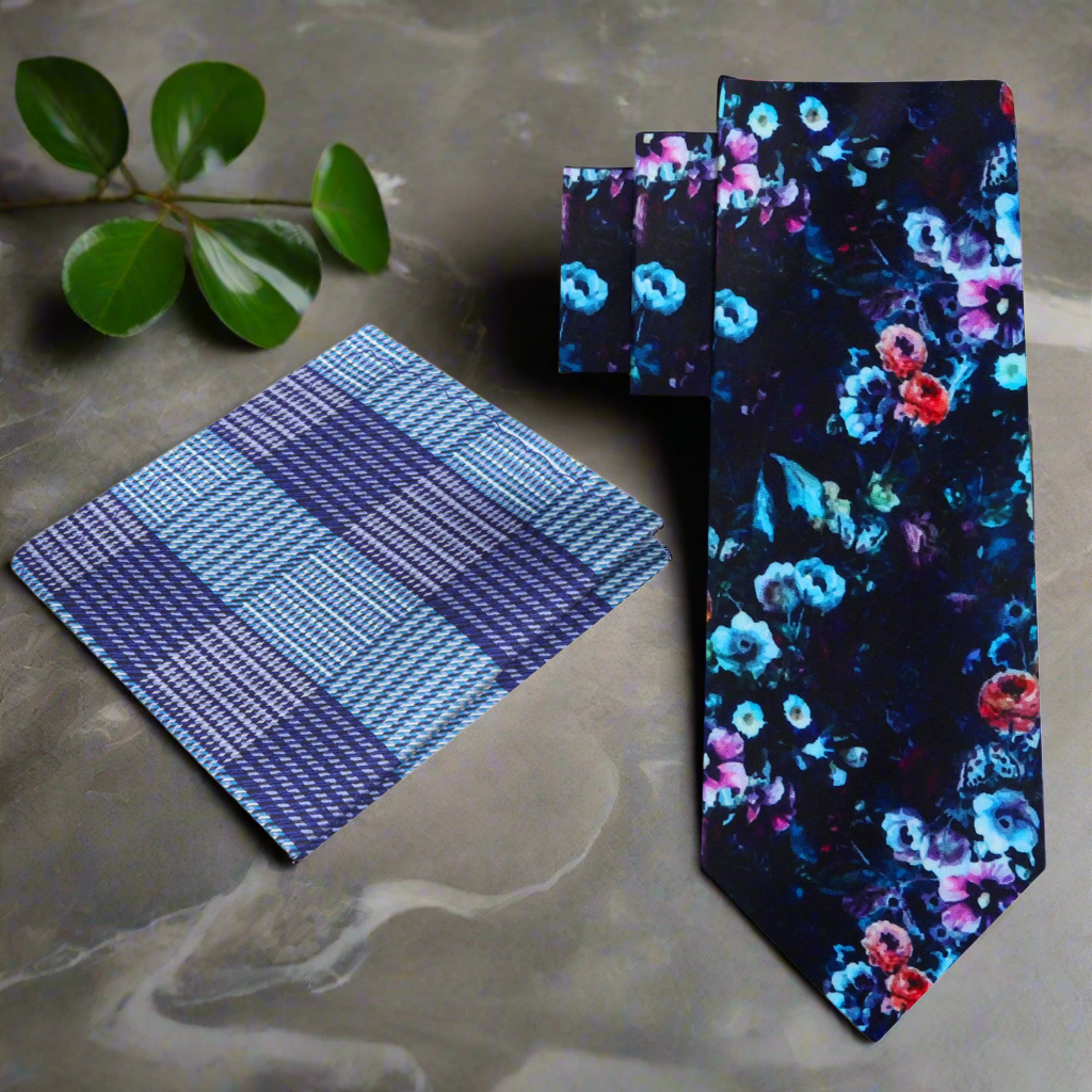 Artistic floral silk tie displayed on a white background, showcasing vibrant colors and intricate floral patterns.