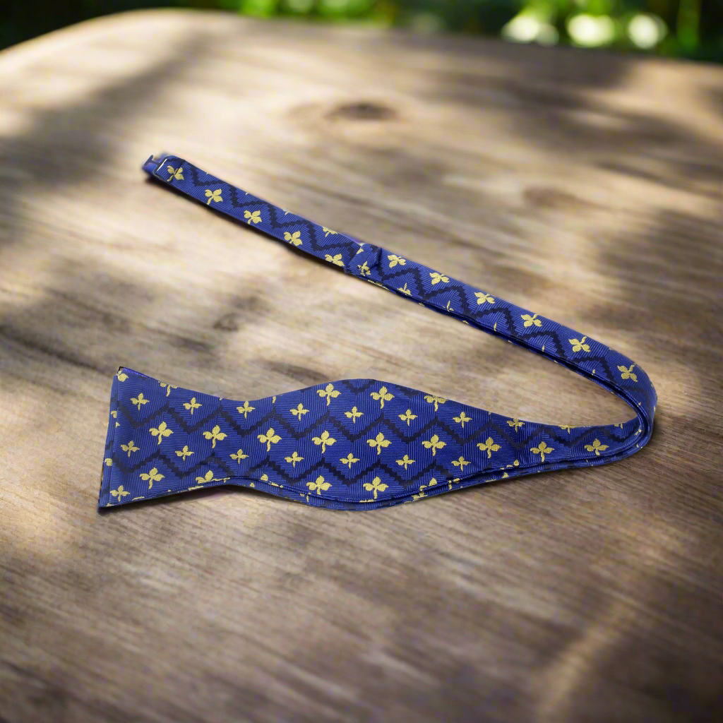 Blue and yellow self-tie bow tie displayed on a white background showcasing its vibrant pattern.