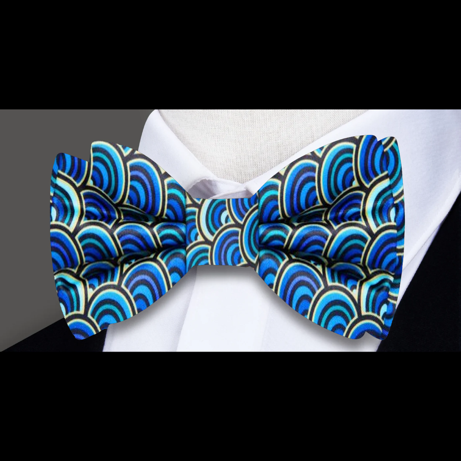 Close-up view of the geometric bow tie with half-circle pattern in blue, green, and yellow.