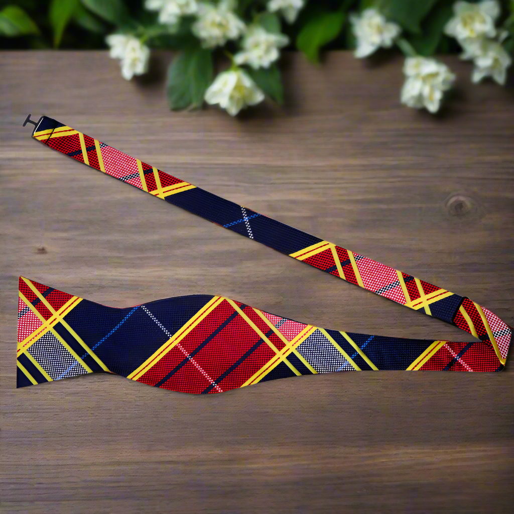 Man wearing plaid bow tie with navy suit at wedding