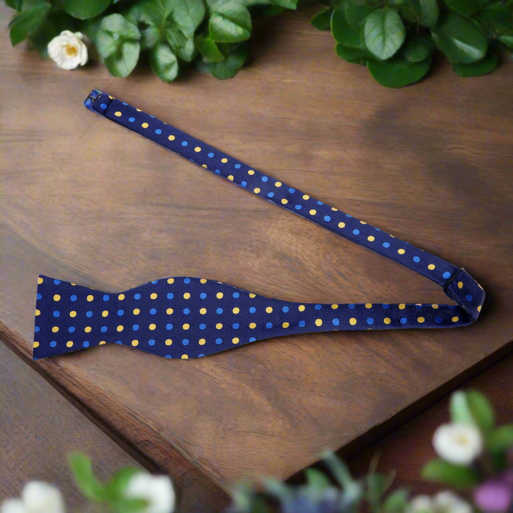 Flat lay of the bow tie next to a light blue shirt, perfect for semi-formal events.