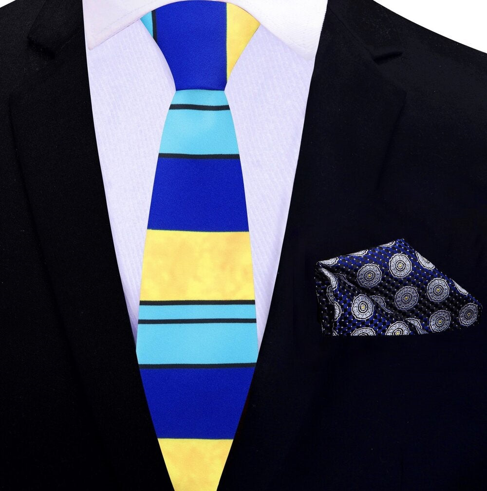 Model wearing the silk tie and pocket square set with a navy suit, demonstrating its versatility for formal events.