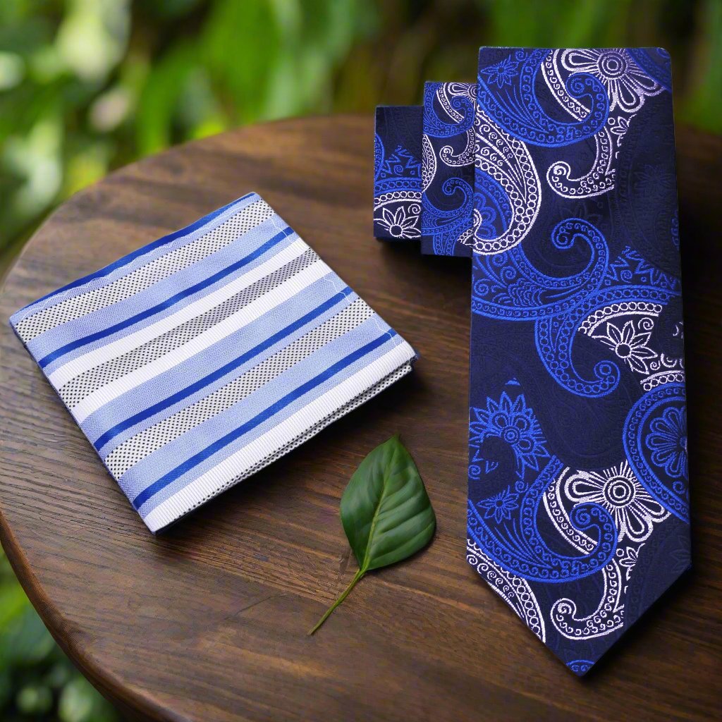 Sophisticated blue paisley necktie displayed with a matching pocket square, showcasing elegant styling.