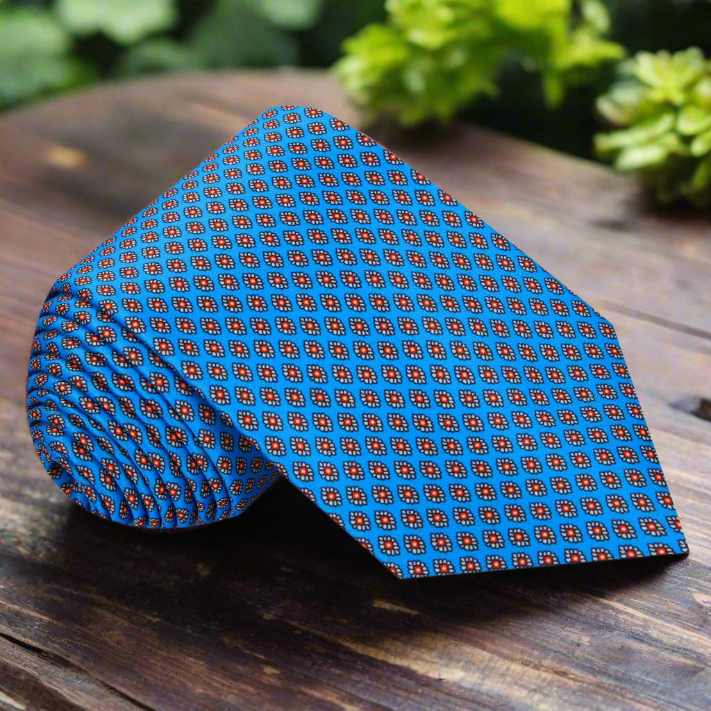 Front view of blue silk tie with red medallion pattern tailored for weddings and business events