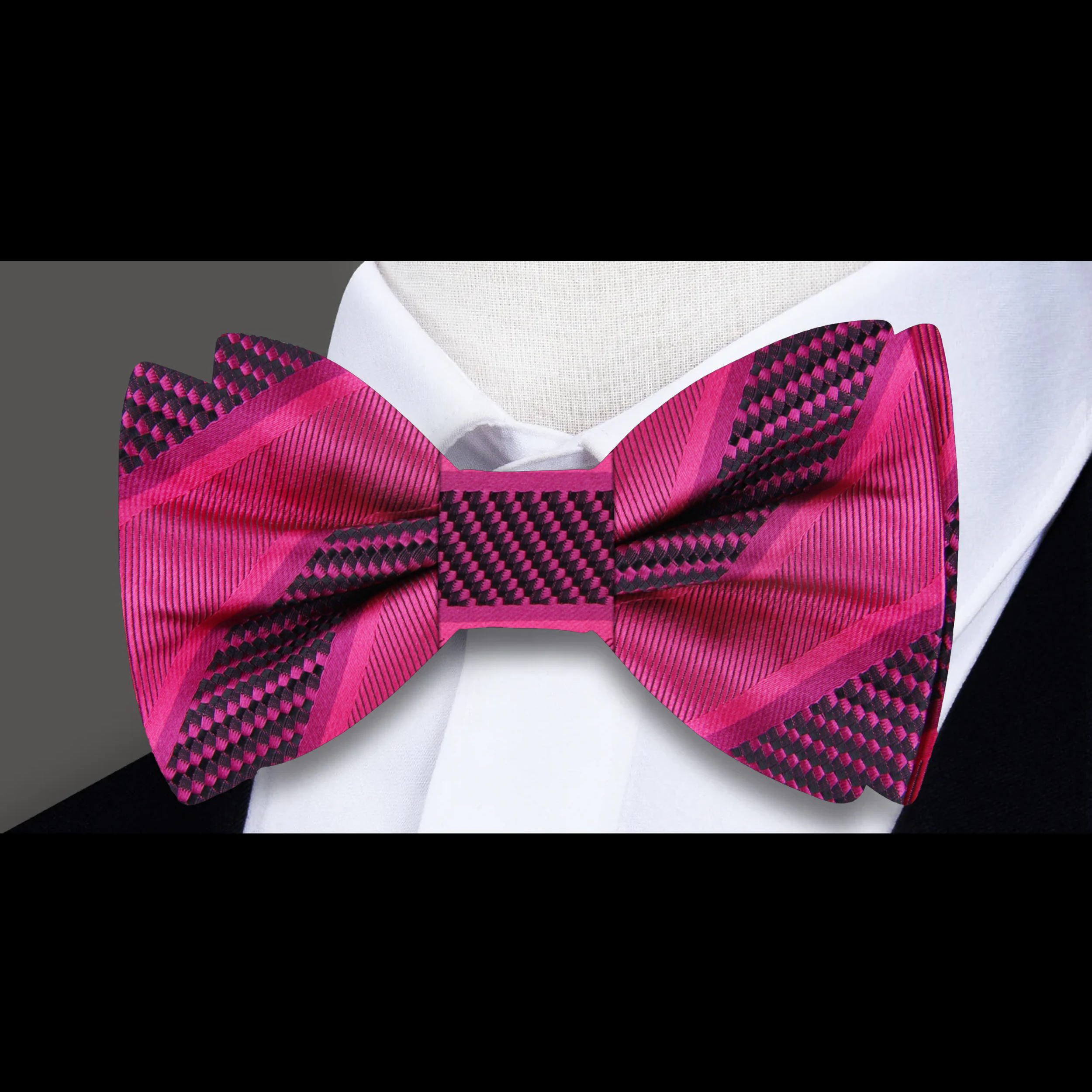 Model wearing a silk striped bow tie with a navy suit for a formal event