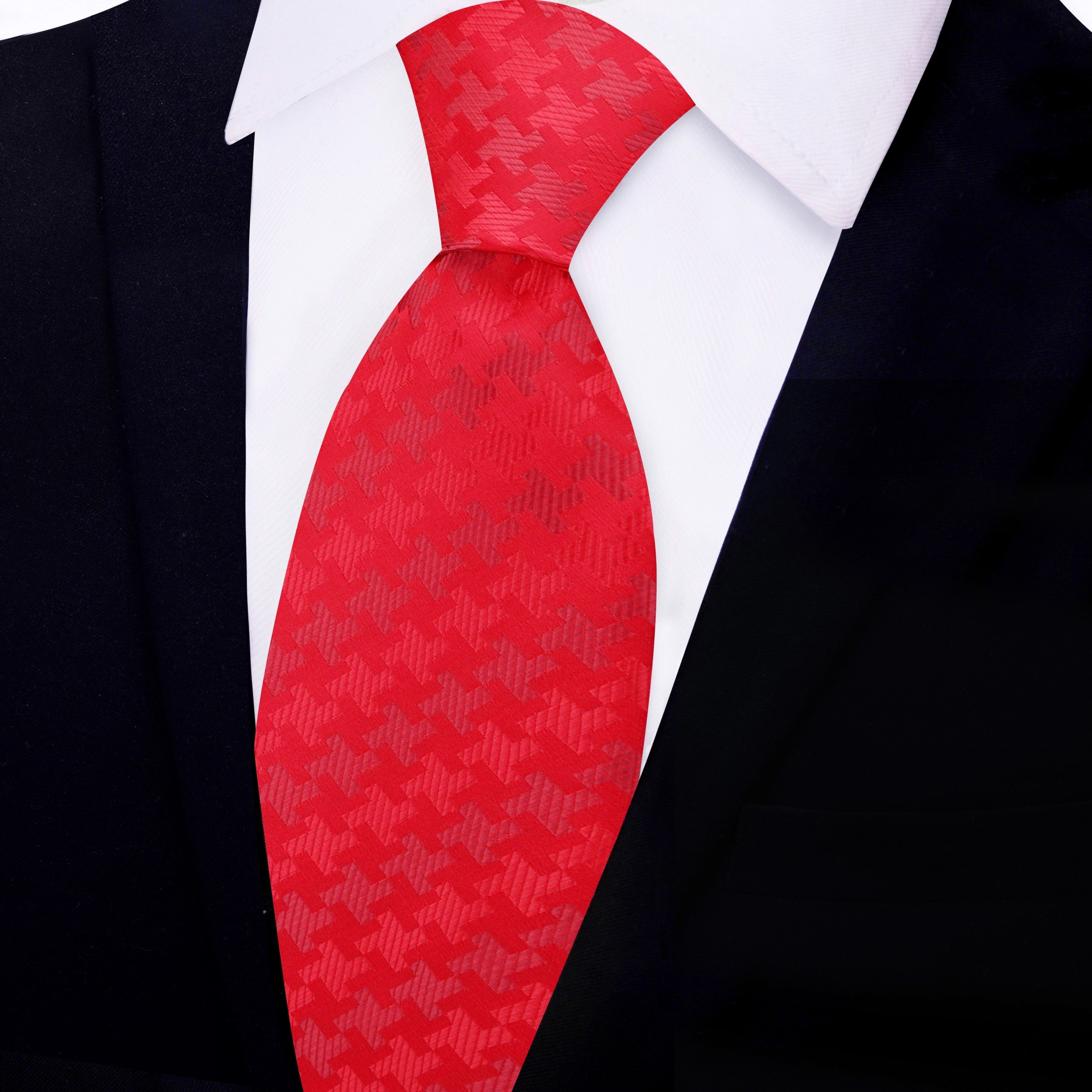 Close-up of the houndstooth pattern on a red silk tie.