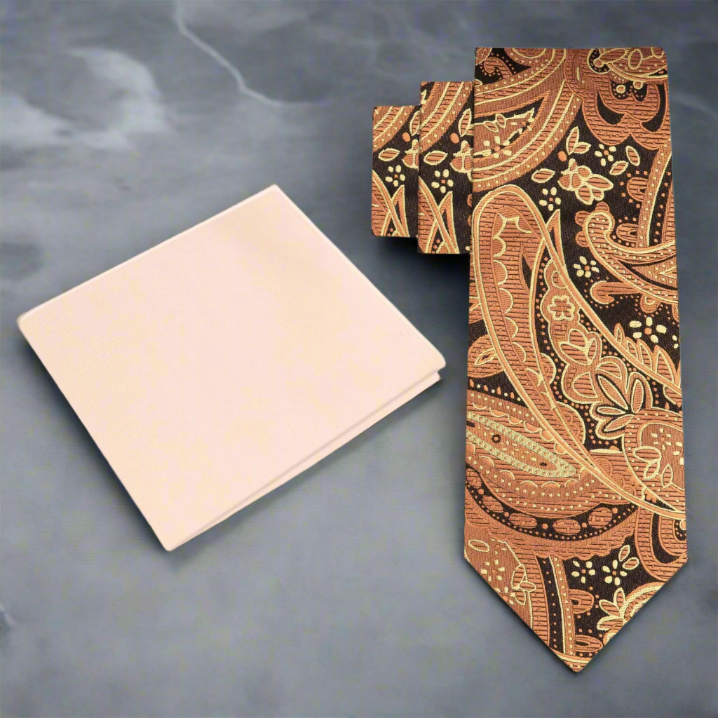 Brown paisley silk tie displayed on a dark suit, ideal for formal events.
