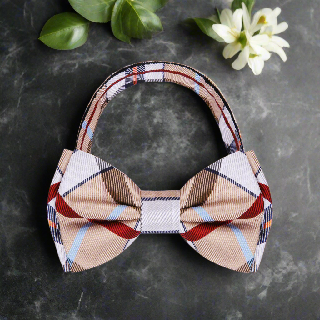 Red and black plaid bow tie with matching pocket square arranged elegantly.