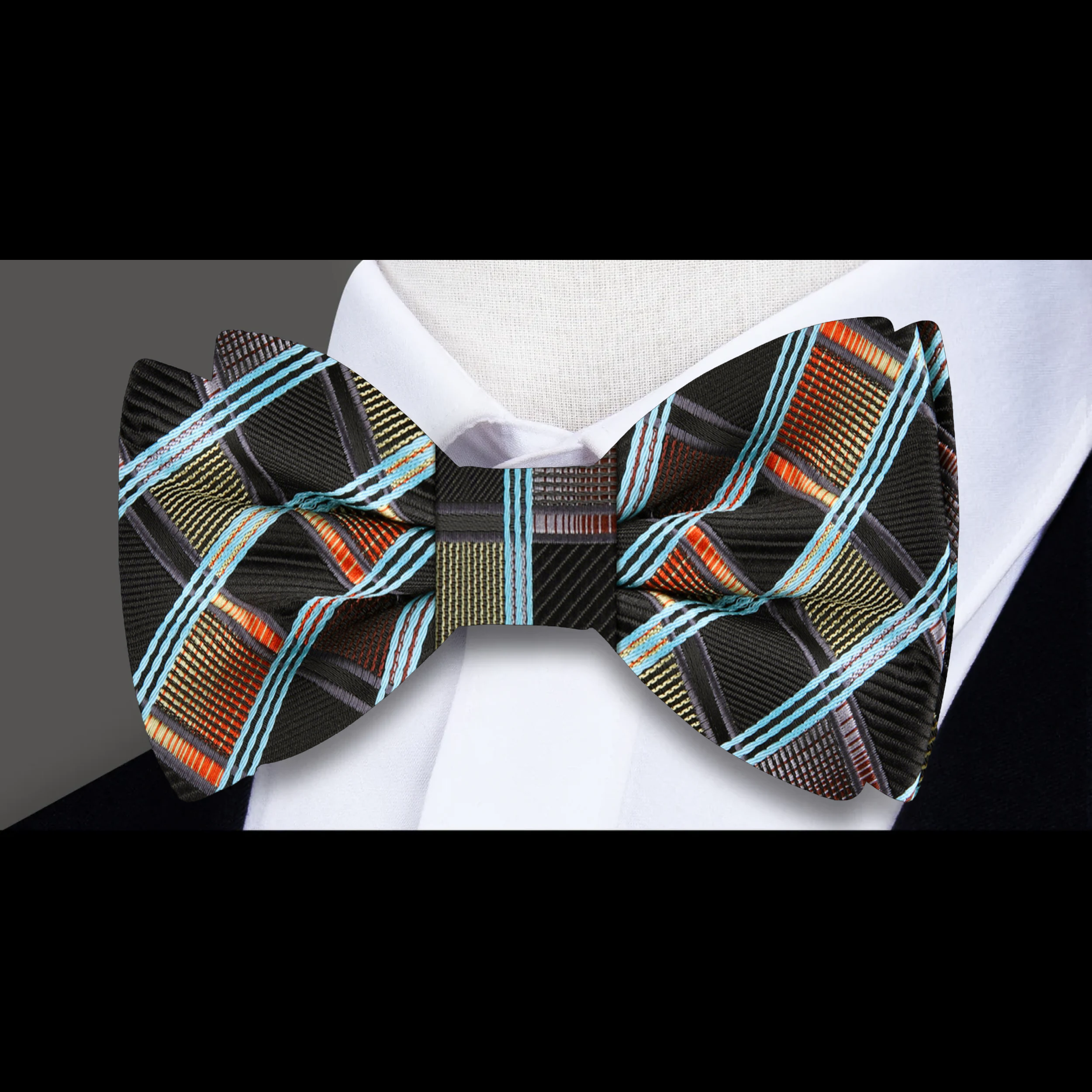 Close-up of the silk fabric and diamond plaid pattern of the mens plaid bow tie