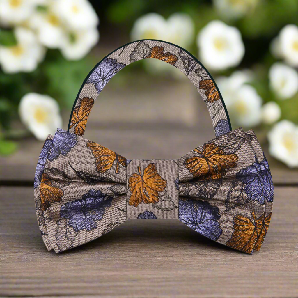 Elegant light brown floral silk bow tie displayed on a crisp white dress shirt, perfect for wedding attire.