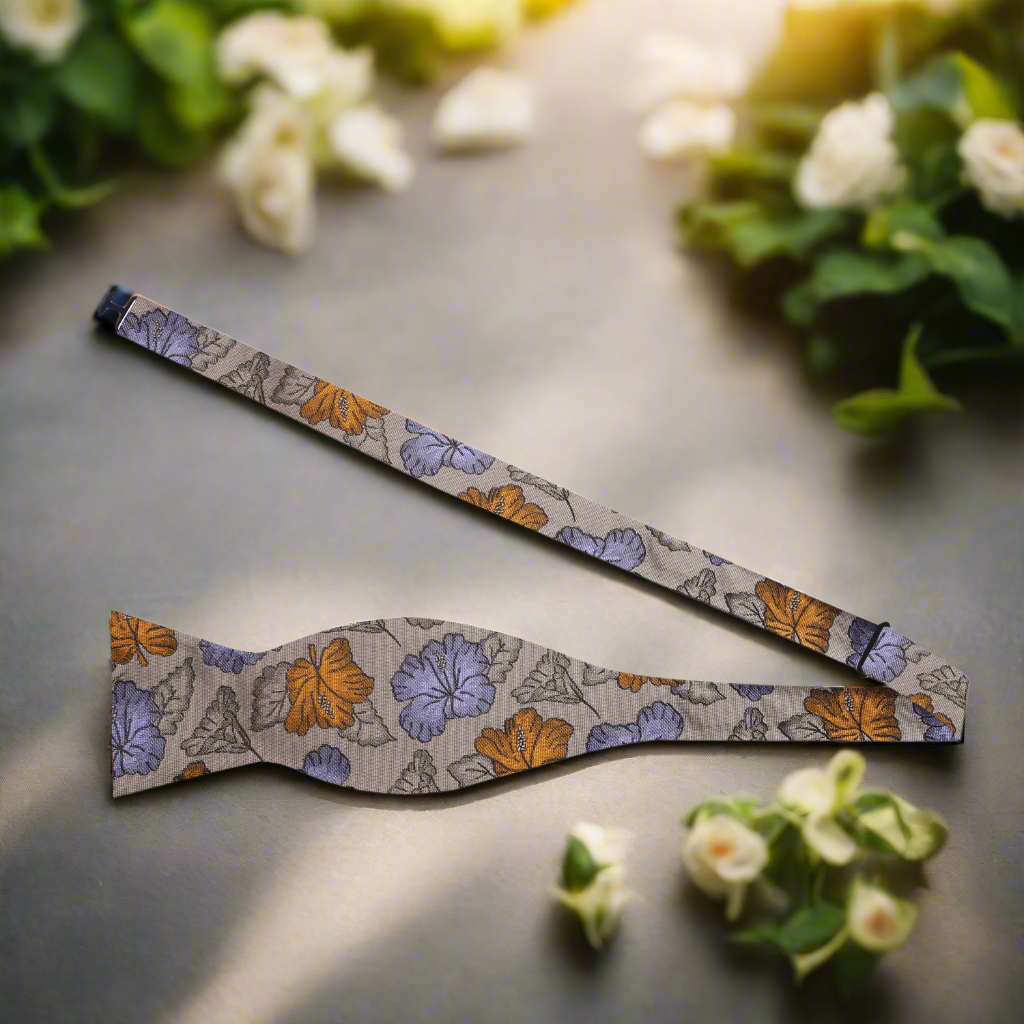 Stylish floral silk bow tie showcased with a navy blue suit, representing sophistication at formal events.