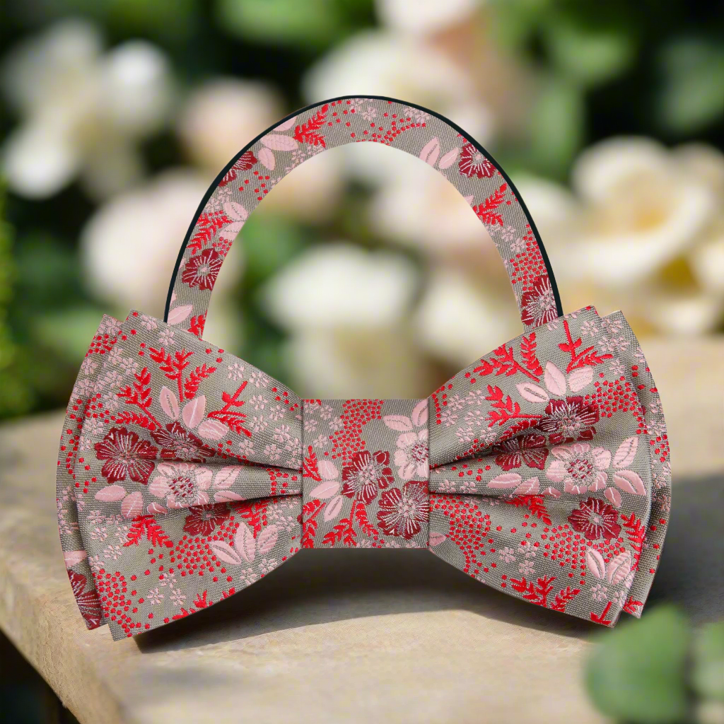 Stylish man wearing a floral bow tie with a crisp white dress shirt at a garden wedding.