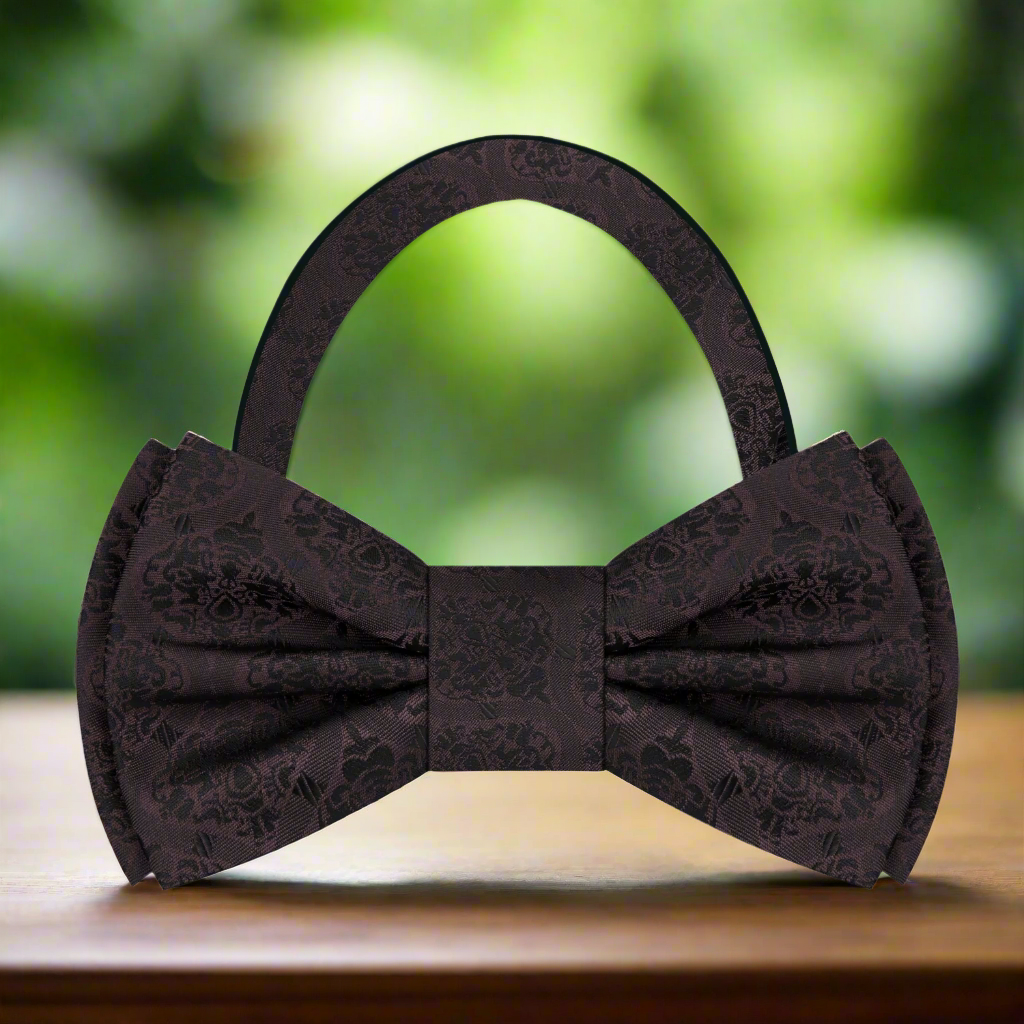 Close-up of the expressive abstract silk bow tie showcasing its vibrant brown and blue pattern.