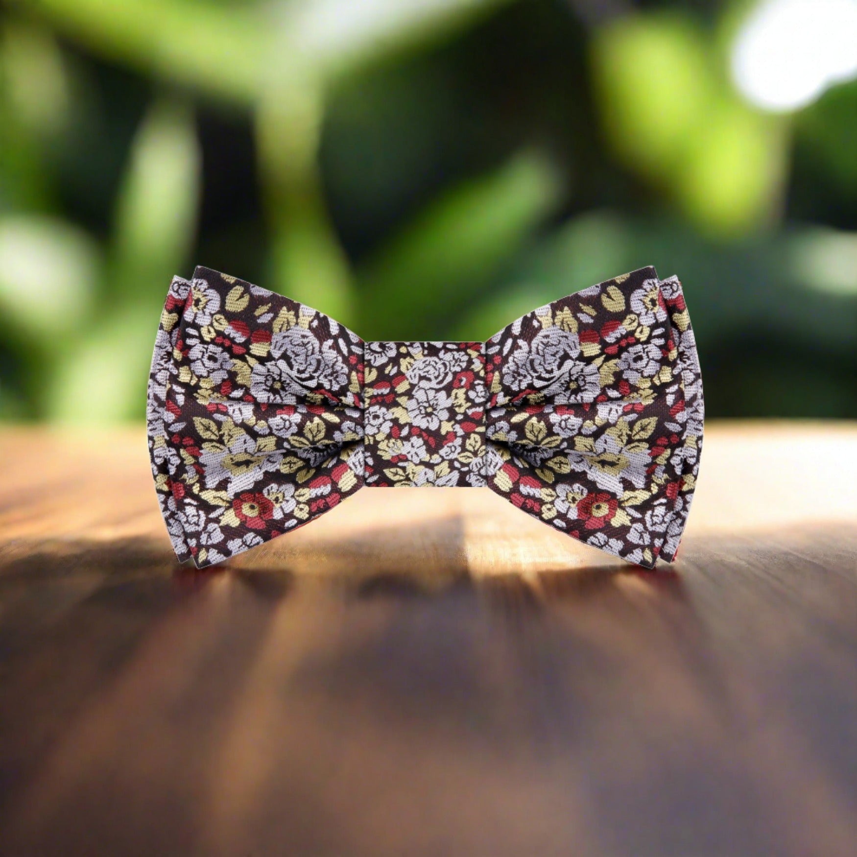 Groom wearing floral bow tie at wedding with formal attire