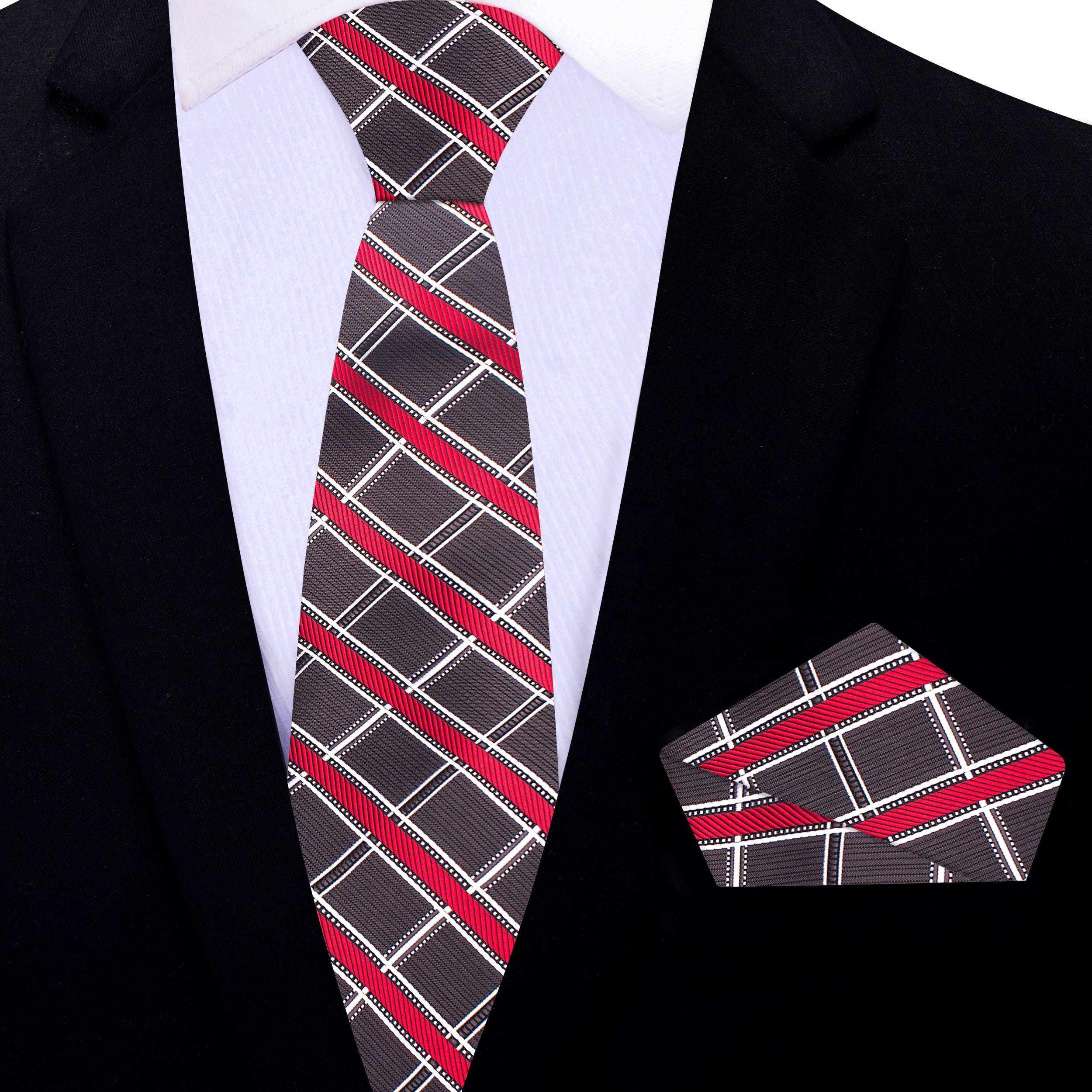 Fashionable man wearing a plaid silk tie and matching pocket square at a wedding