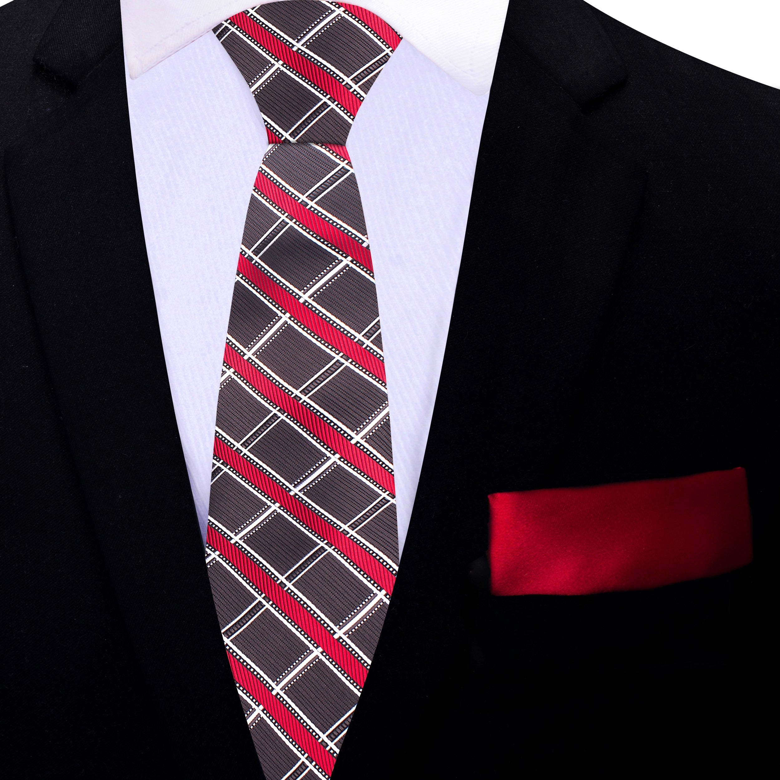 Fashionable man wearing a plaid silk tie and matching pocket square at a wedding