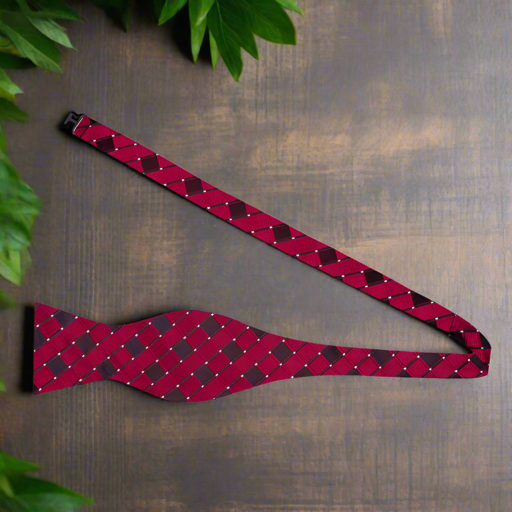Close-up of geometric bow tie in burgundy silk, highlighting diamond pattern