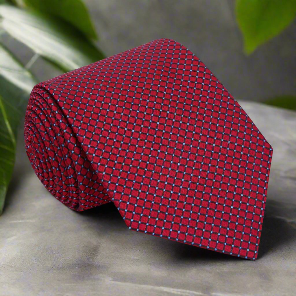 Elegant deep red silk necktie displayed on a stylish background, showcasing the geometric pattern.