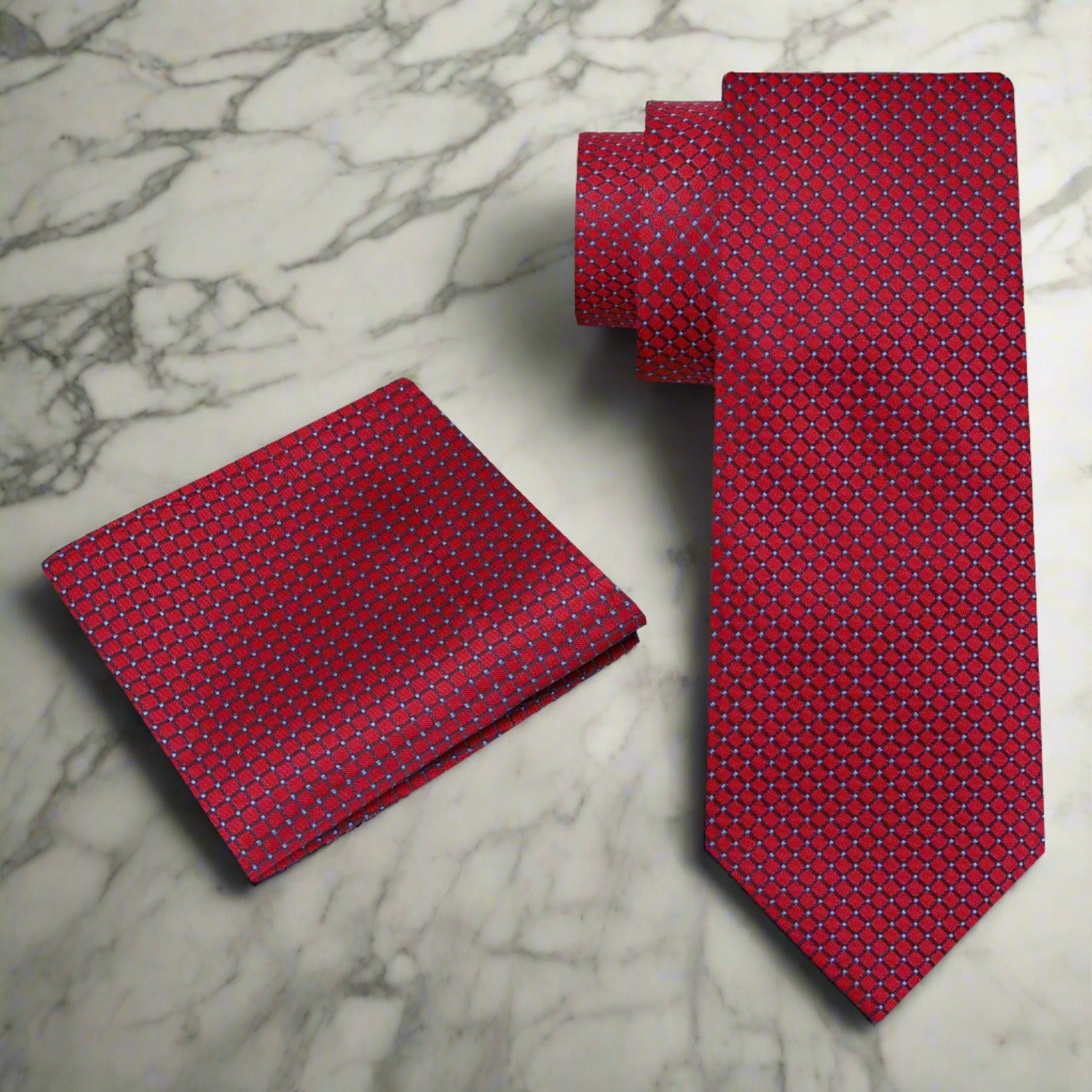 Model wearing an elegant deep red geometric silk necktie paired with a navy suit at a wedding.