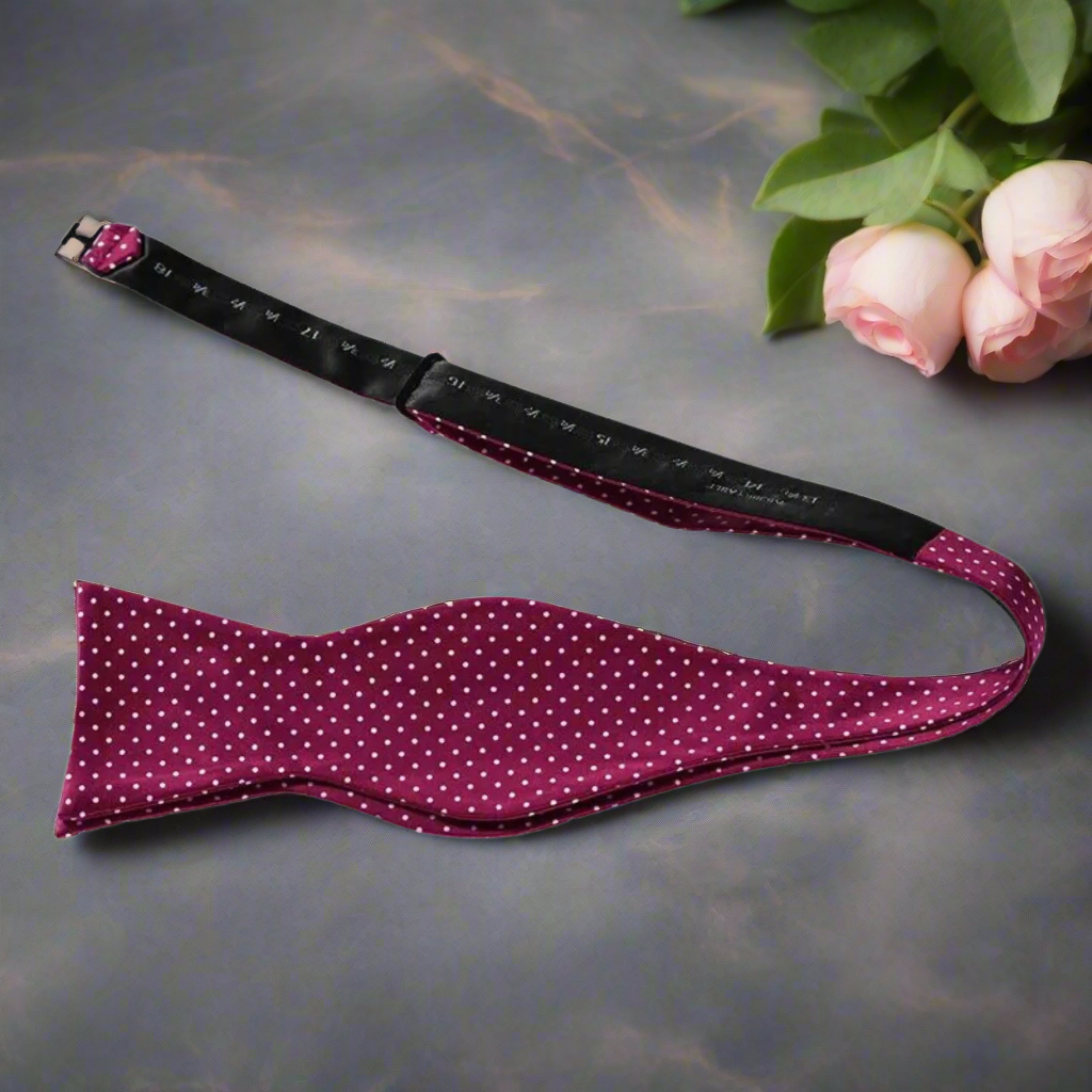 Close-up of burgundy microdot silk bow tie, highlighting its subtle contrast and elegance.