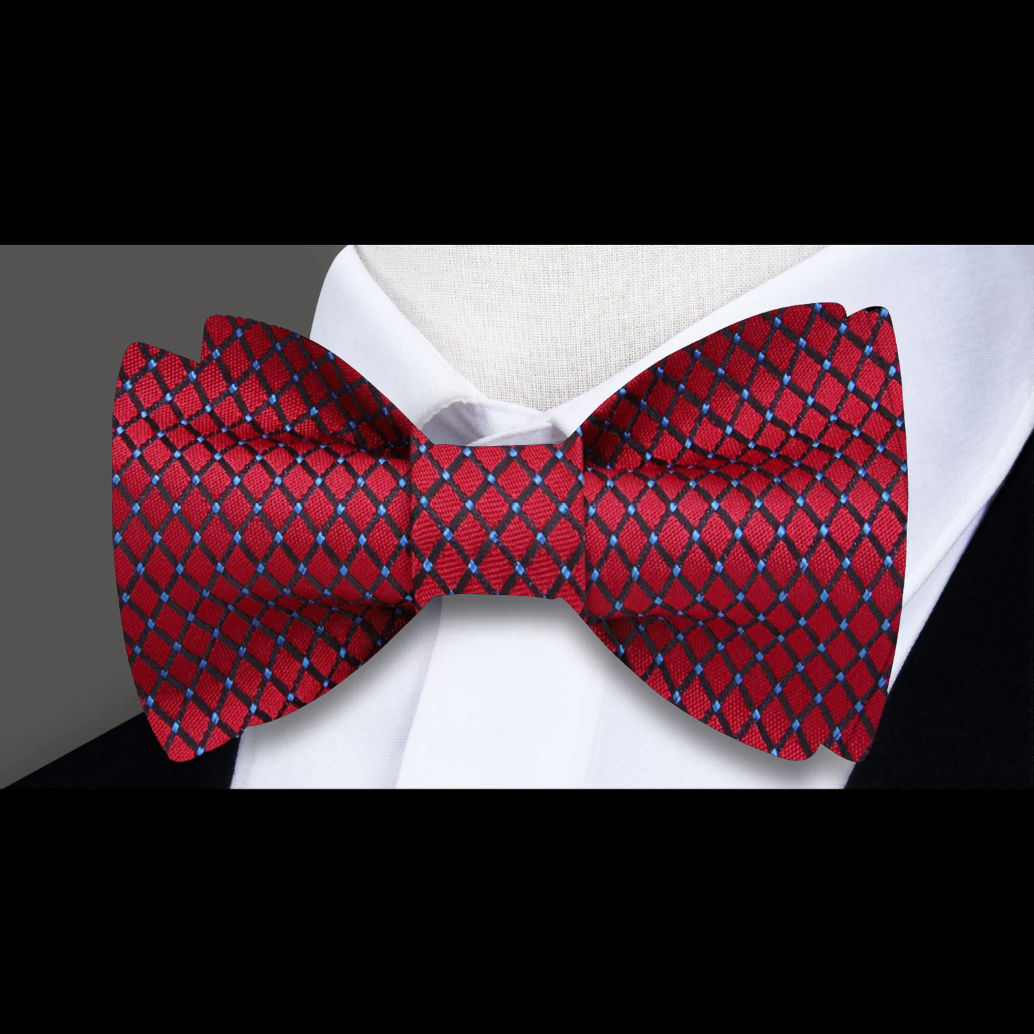 Man adjusting a pre-tied bow tie in a formal setting, showcasing the intricate check pattern