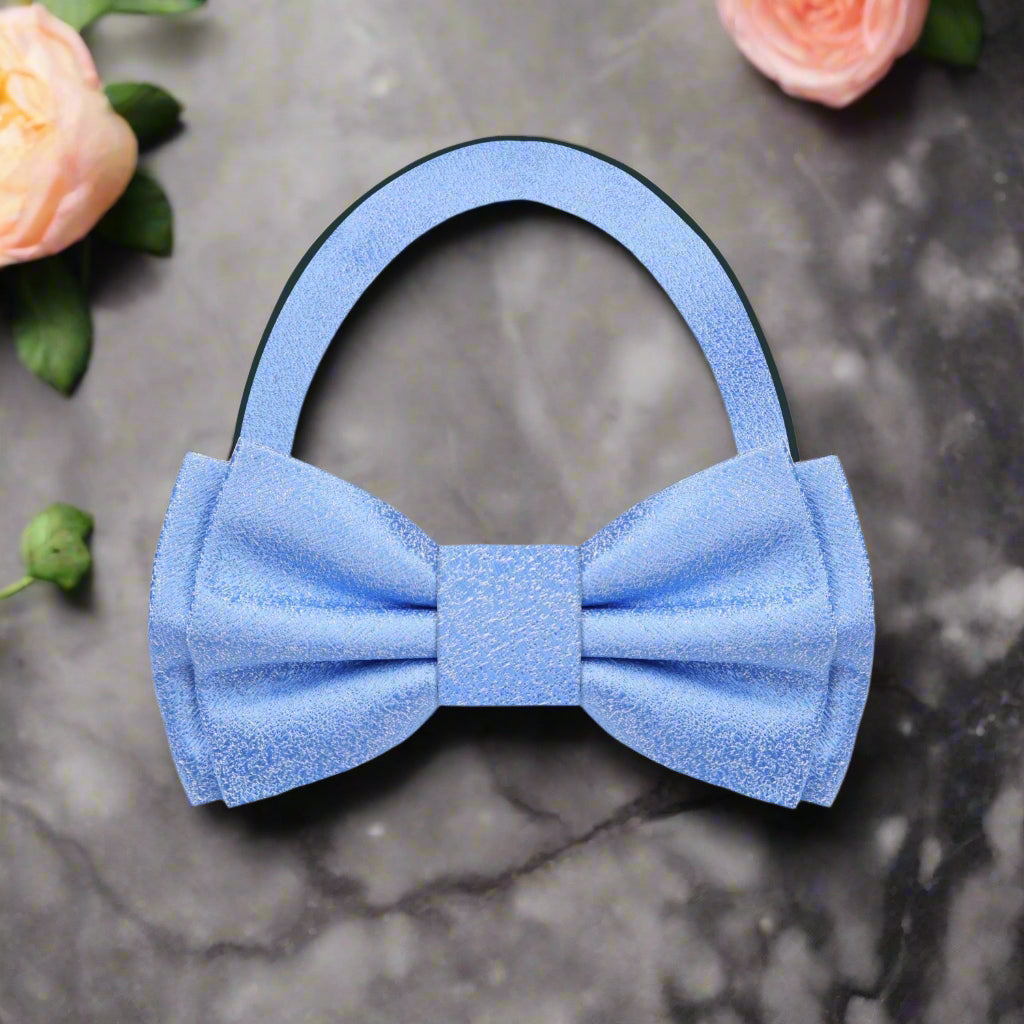 Styled image of a pink textured bow tie paired with a light blue shirt, perfect for outdoor gatherings.