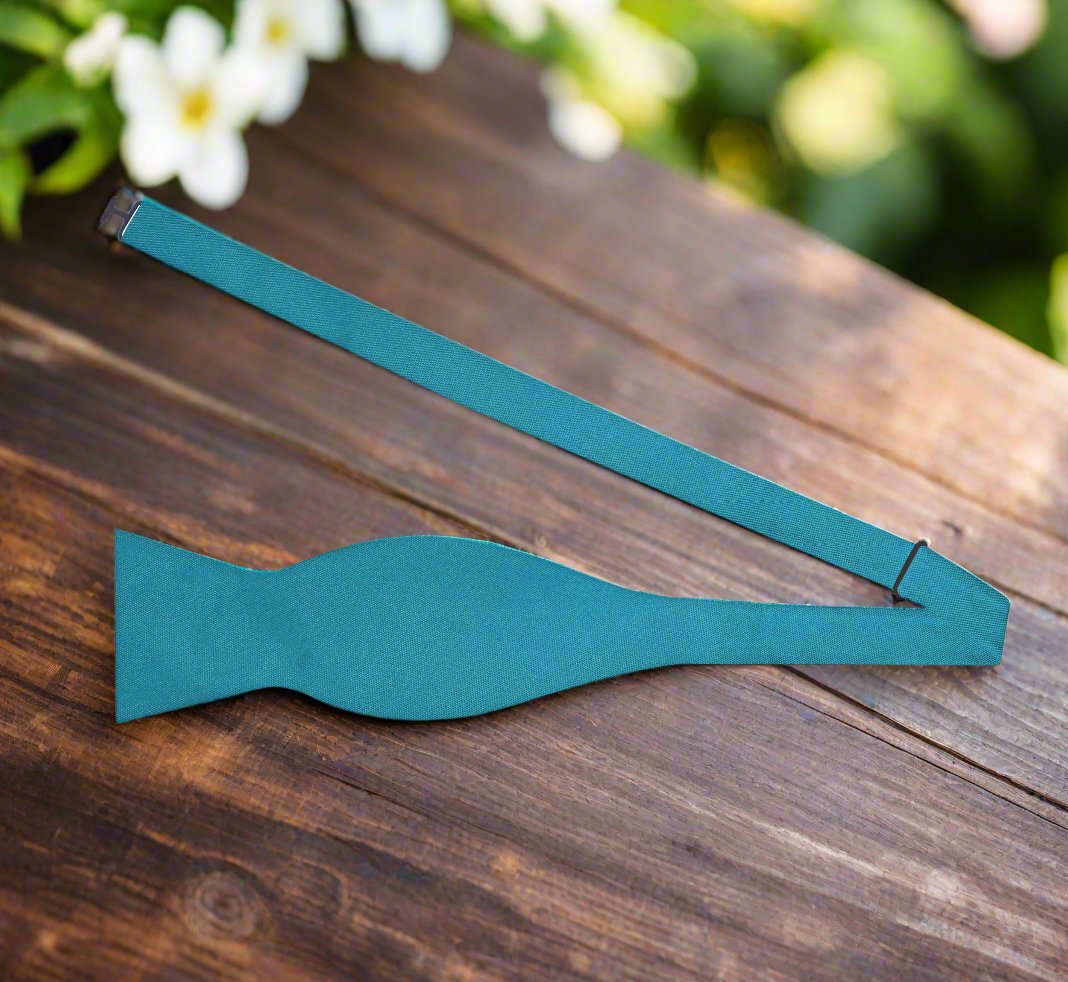 Styled mens bow tie with a navy blue suit for a wedding or summer celebration