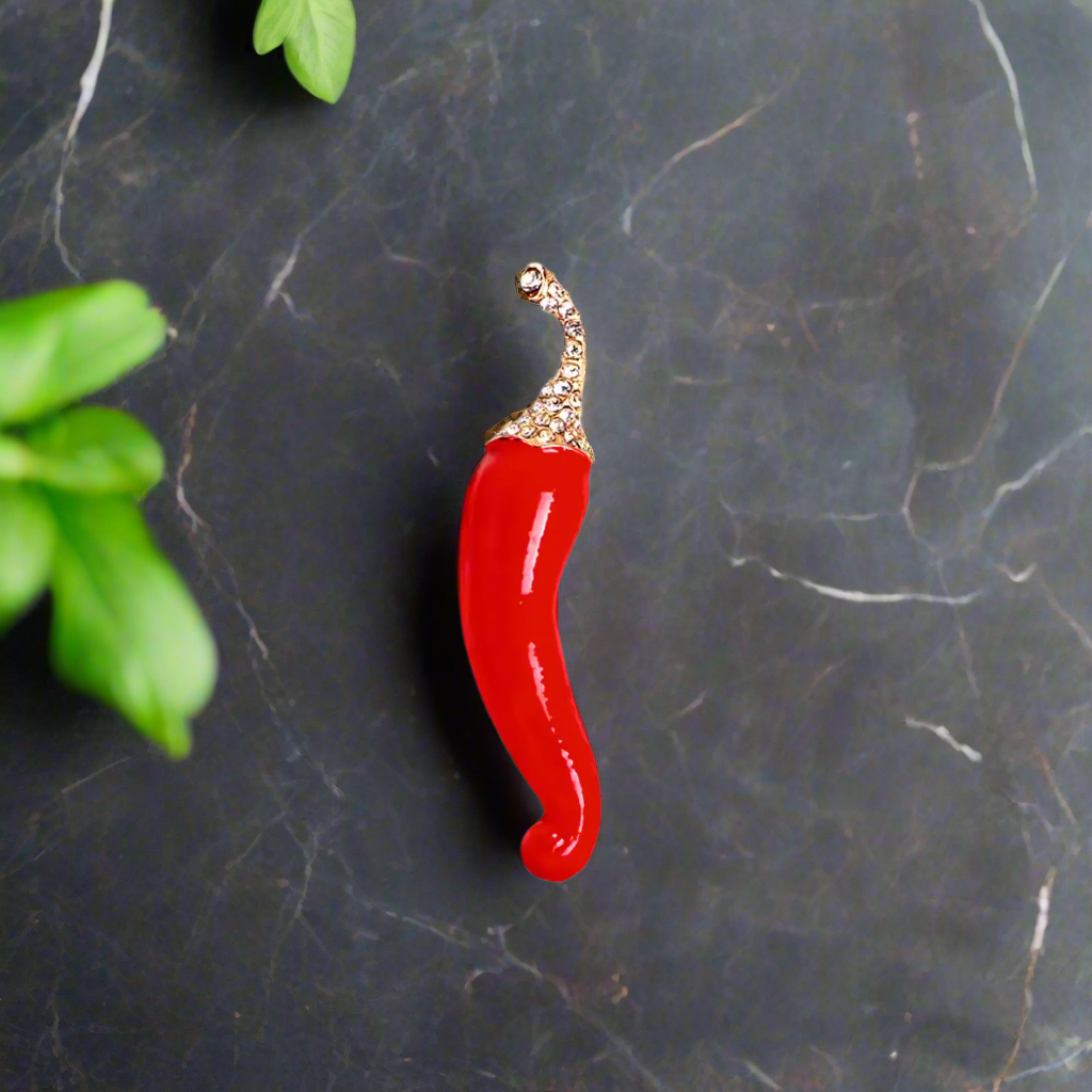 Close-up view of the spicy cayenne pepper lapel pin showcasing its vibrant red color and intricate details.