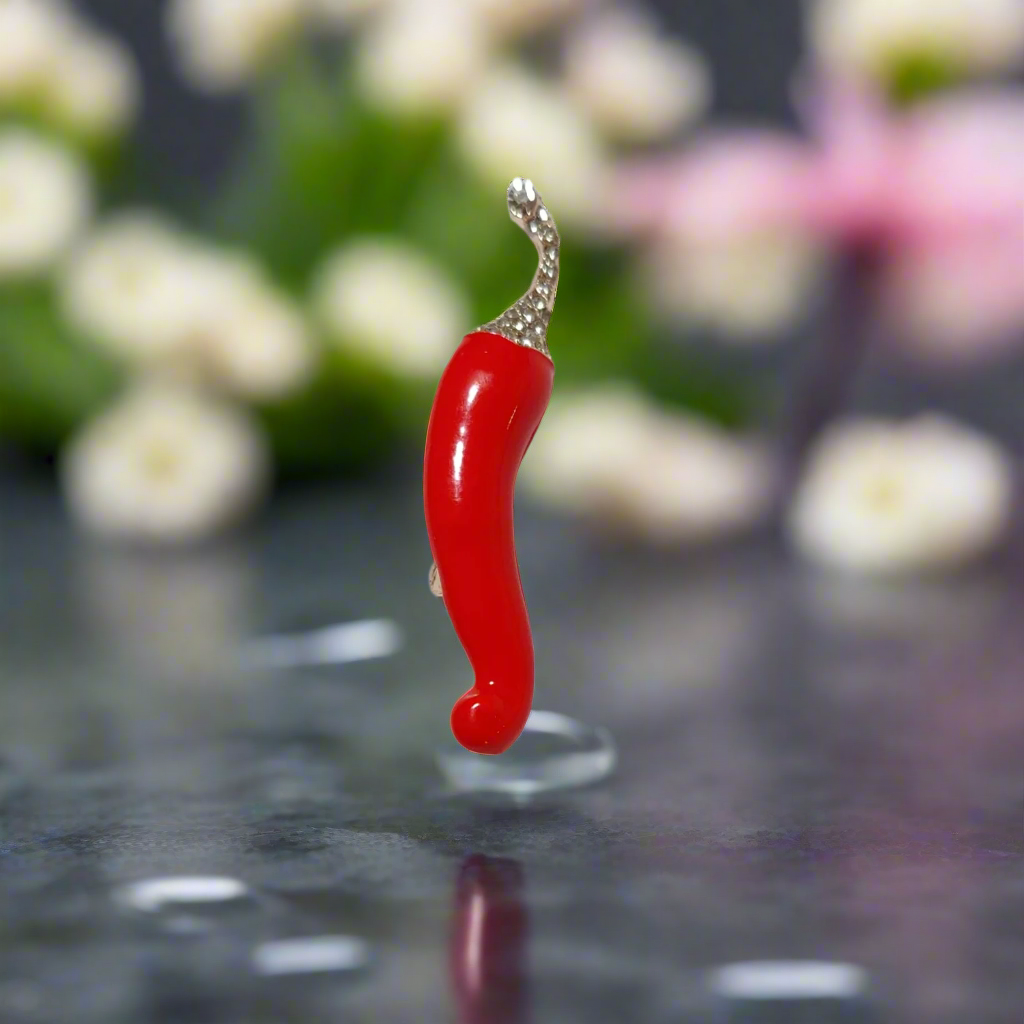 Cayenne pepper lapel pin worn on a light grey shirt, highlighting its playful design and stylish pairing.