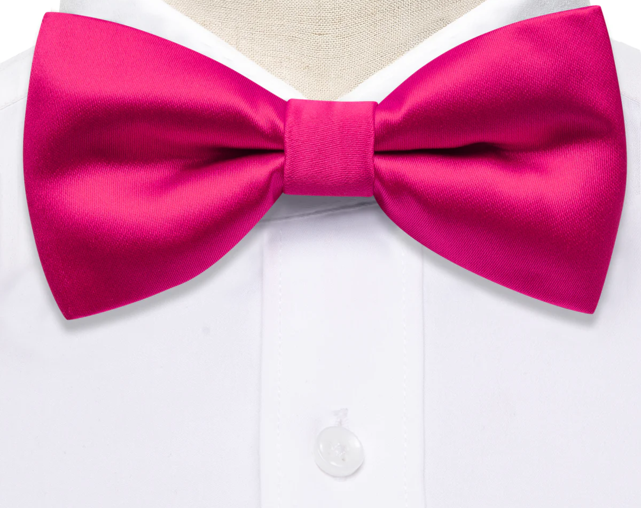 Close-up of a pre-tied pink bow tie showcasing luxurious silk fabric