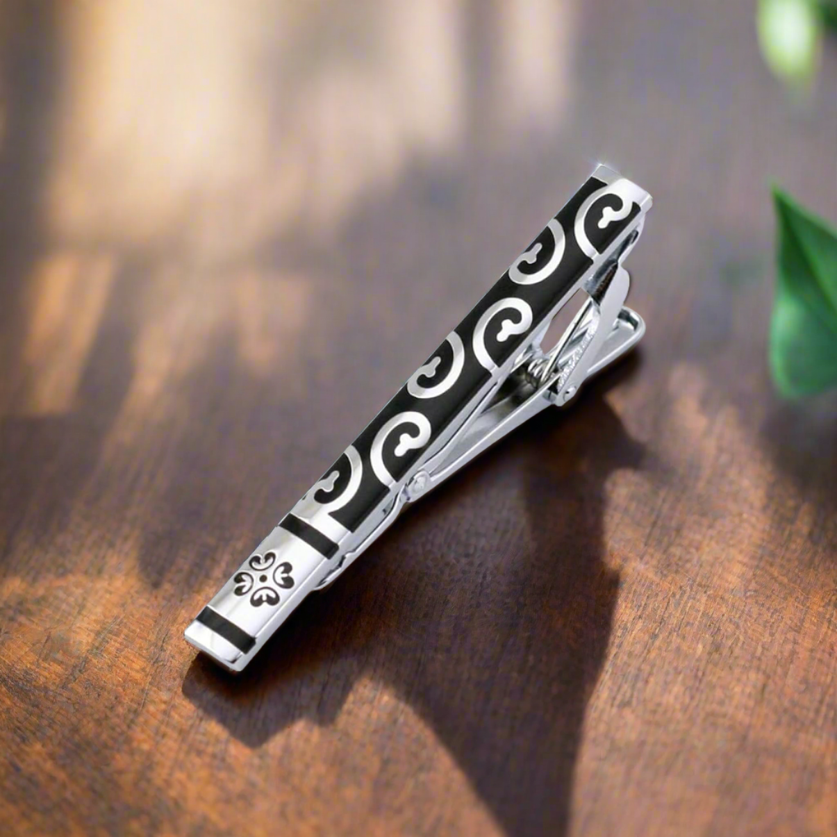 Zebra pattern tie bar with stone accents, ideal for a unique and stylish look.