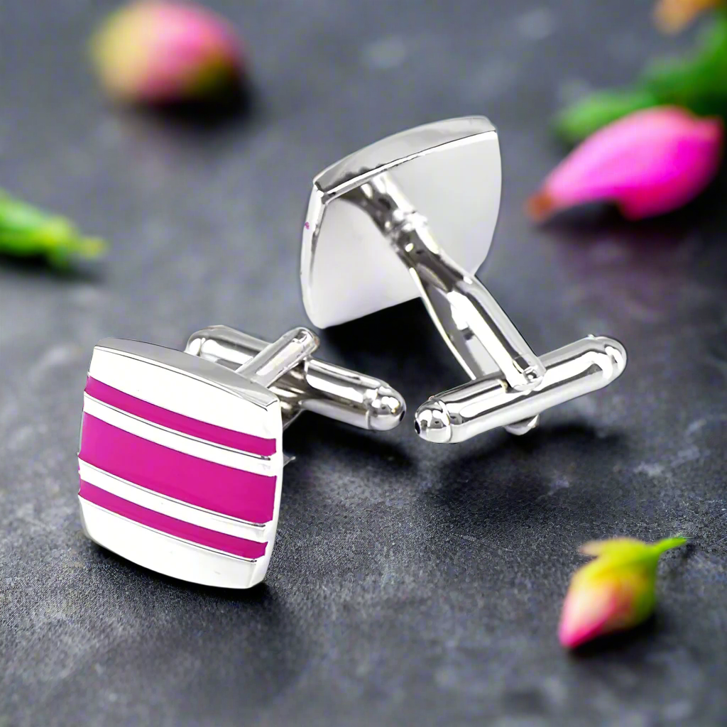 Luxury chrome cufflinks with red stone, angled view