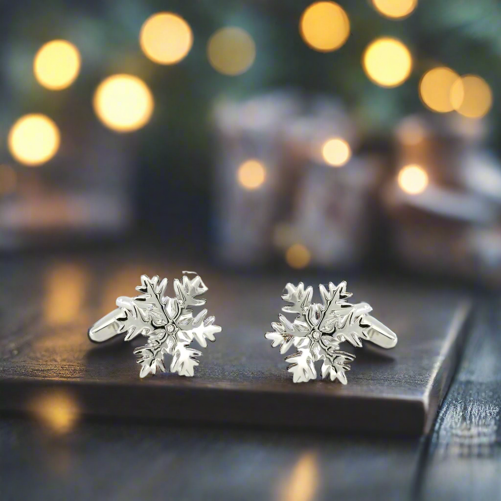 Close-up of shiny chrome cufflinks with snowflake pattern for winter fashion