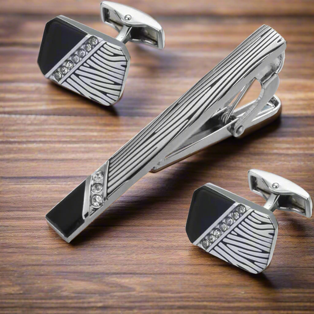 Close-up of zebra pattern tie clip and cufflinks set with stones