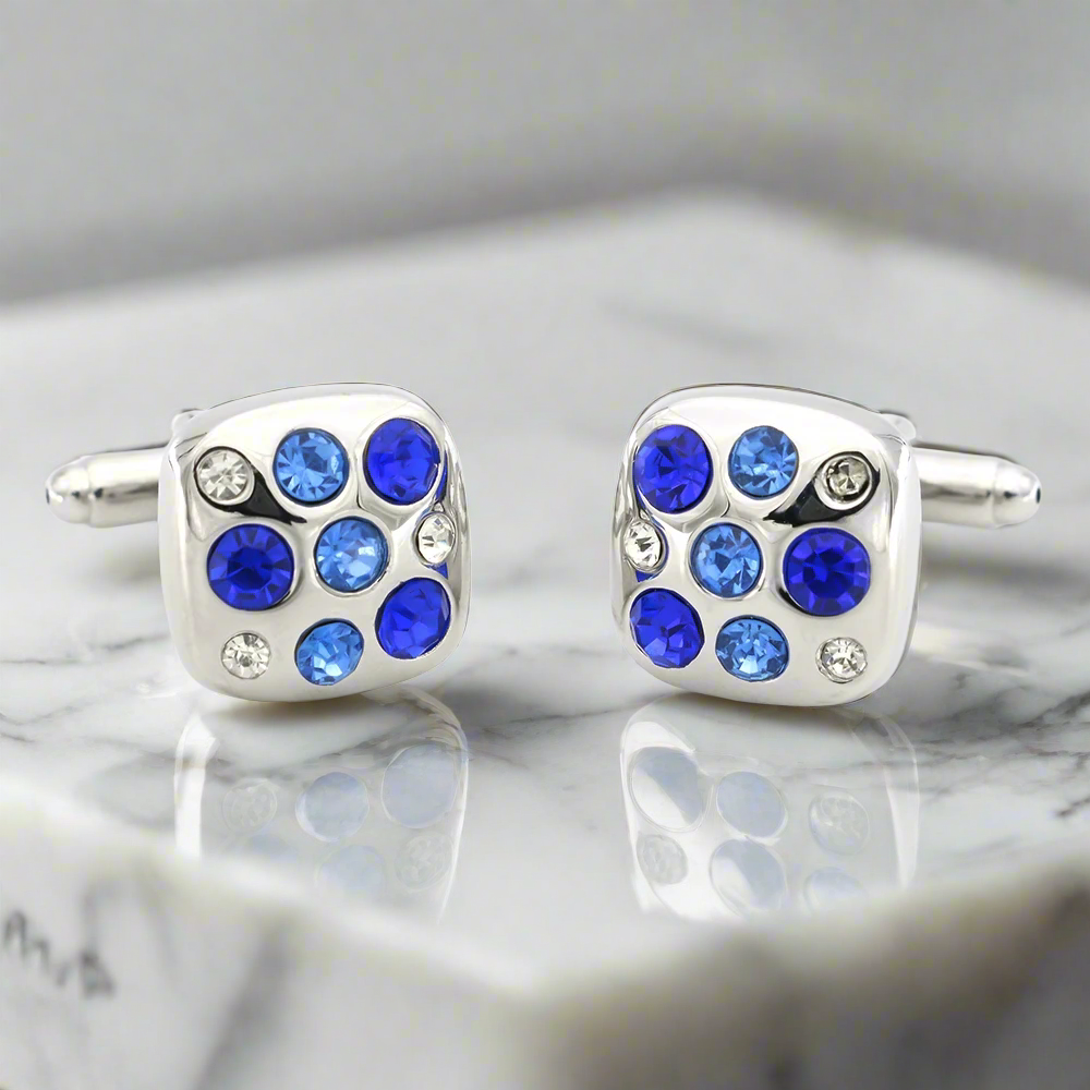 Close-up of blue gemstone cufflinks in square shape on a formal shirt