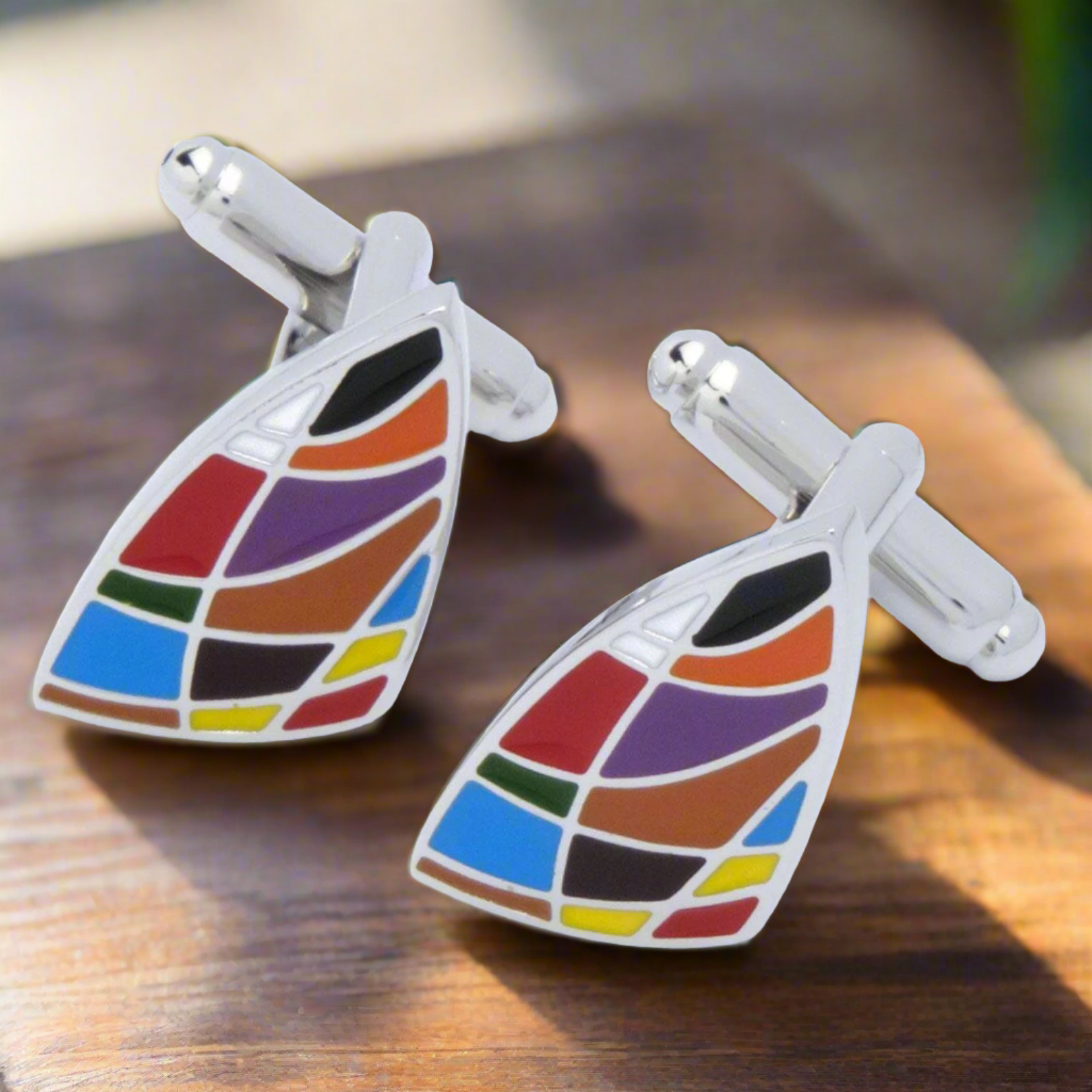 Close-up view of unique geometric cufflinks in various designs and colors.