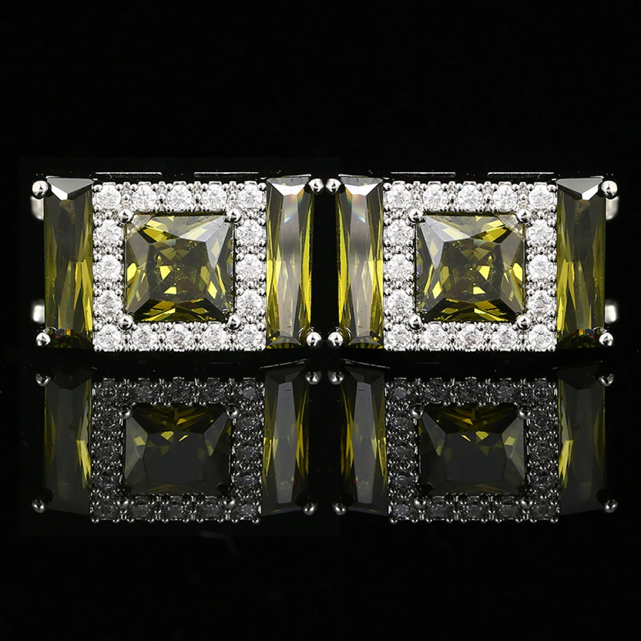 Gold gemstone cufflinks with clear stones, showcasing a luxurious design.