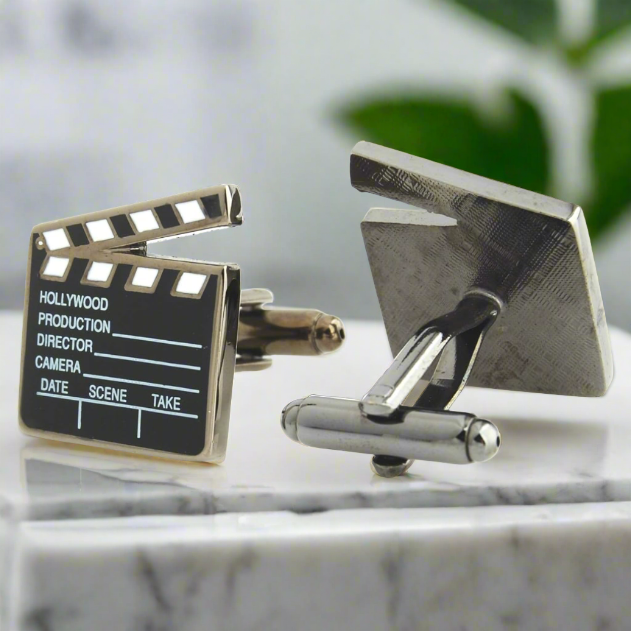Directors clapboard cufflinks styled with a charcoal gray suit — ideal for premiere parties
