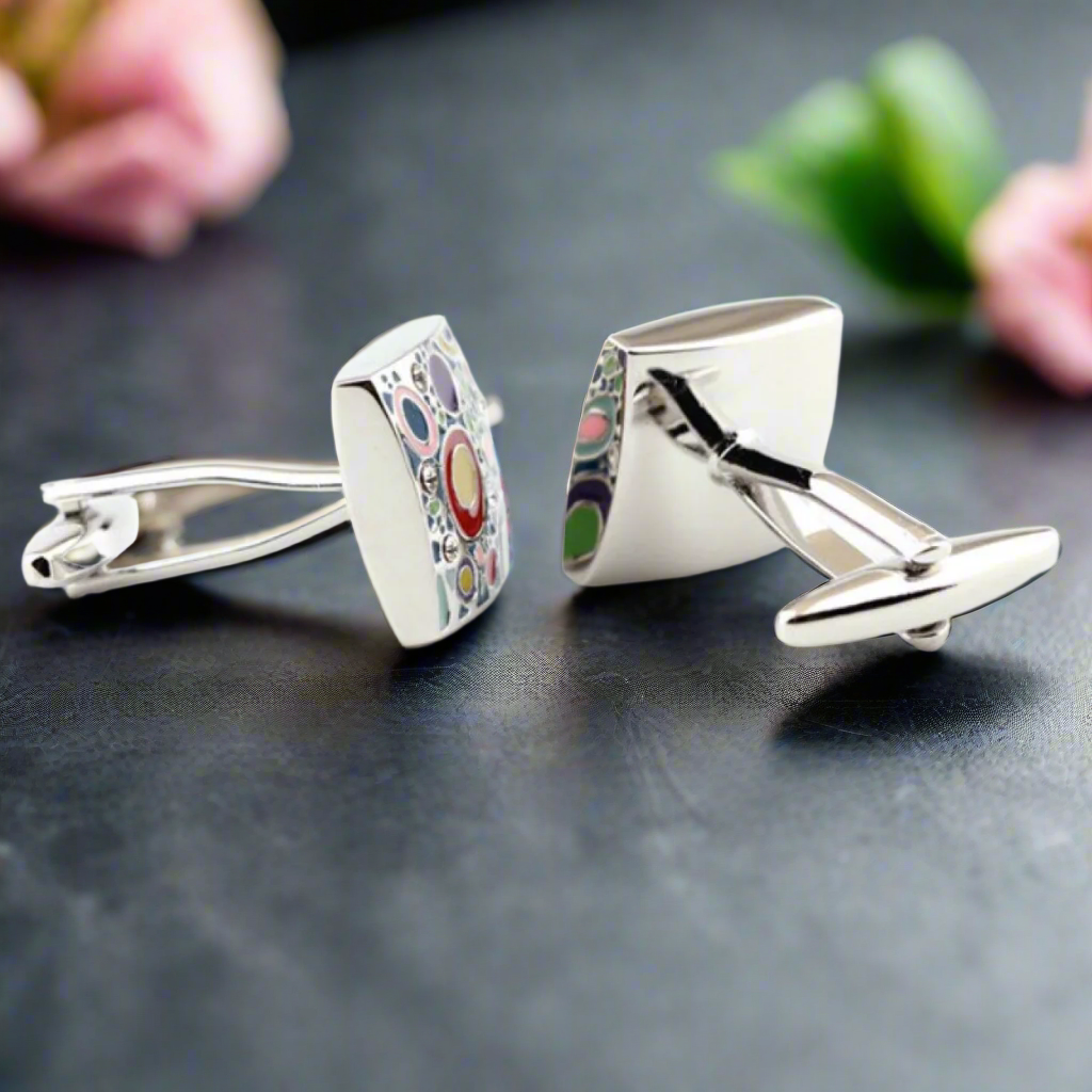 Pair of chromatic circles cufflinks with reflective chrome finish and colorful motifs