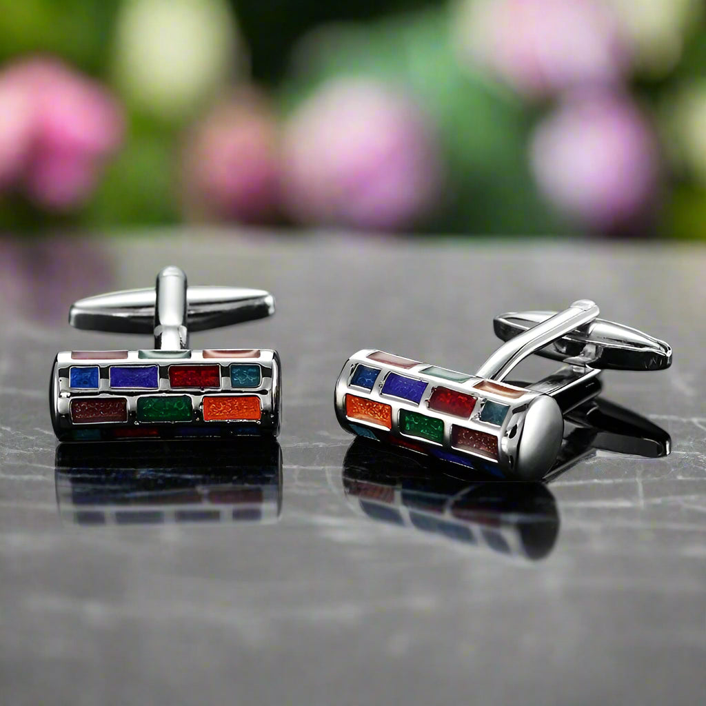 Close-up view of unique geometric cufflinks in various designs and colors.